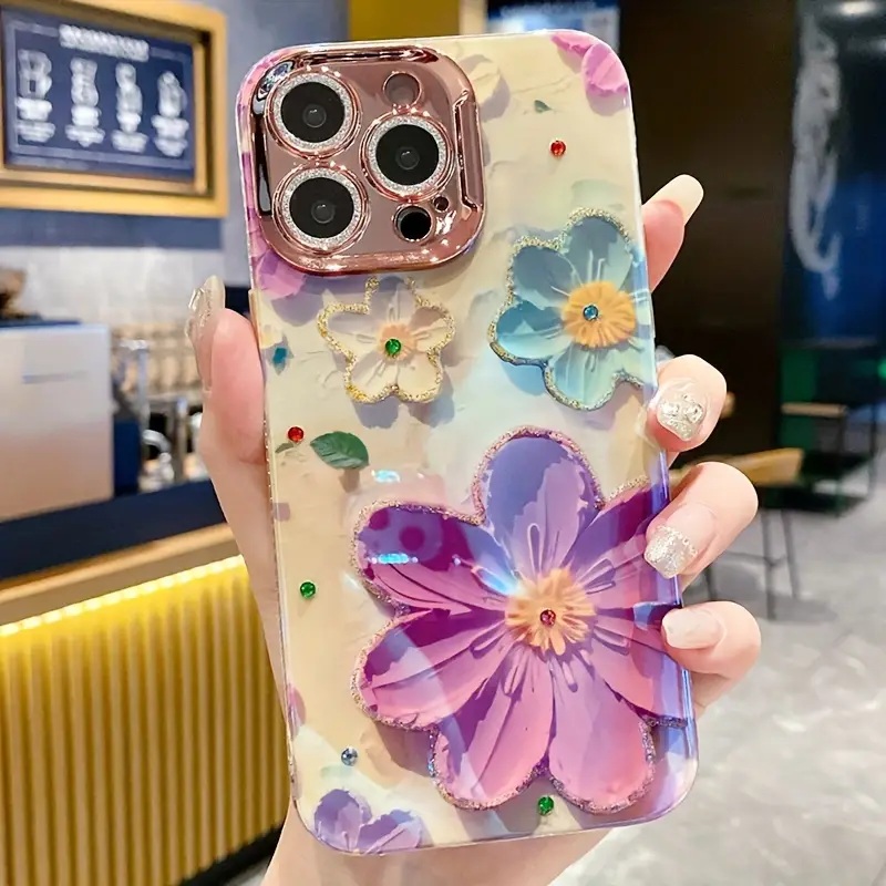 Floral iPhone case with colorful 3D flower patterns and shiny rose gold camera frame.